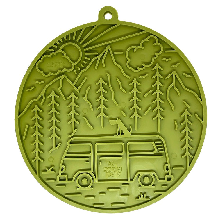 Green silicone lick-mat with camping design featuring a van and trees on a white background. Intended for dogs.