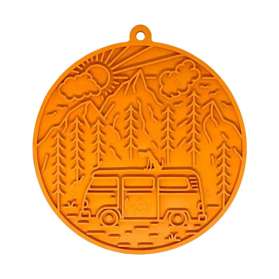 Orange food-grade silicone lick mat for dogs with nature-themed design featuring a van, trees, and mountains. 
